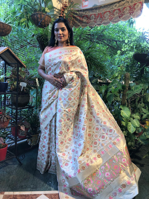 Banarasi ektara soft silk saree with multicolor meena work on a cream and gold base.