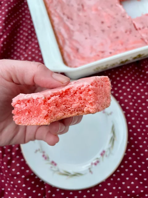 Bite out of a strawberry cake mix brownie.