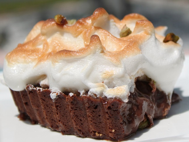 this tart is has a chocolate crust filled with mousse and topped with meringue