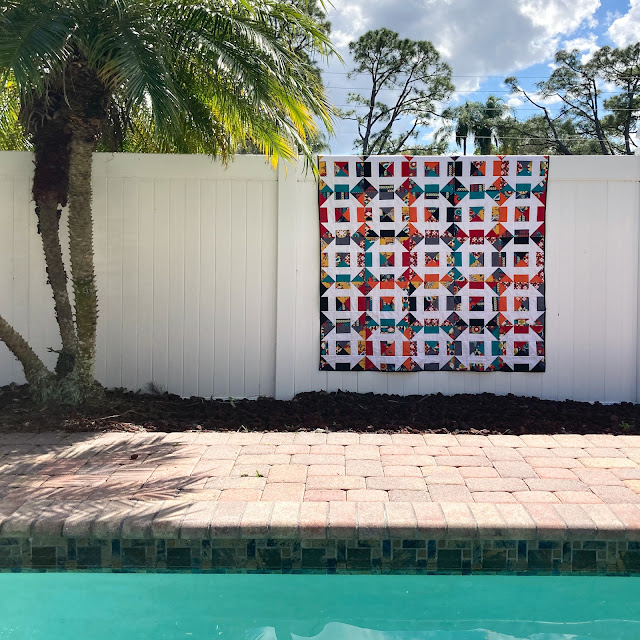 Bejeweled Churn Dash Quilt near the swimming pool