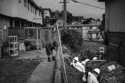 a  Resident Talks to Workers in the yards outside in the Hunter's Point Neighborhood of San Francisco, Calif