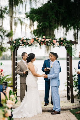 bride and groom holding hands at altar