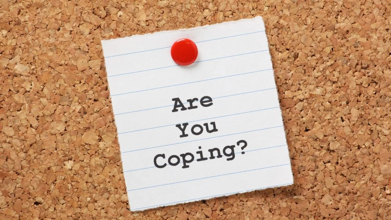 Are you coping? On paper note pinned to a cork notice board.