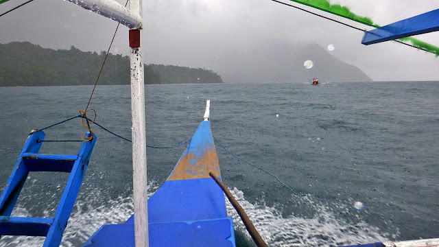 boat travel under the rain from St. Paul Cave and Underground River also known as Puerto Princesa Underground River to Sabang