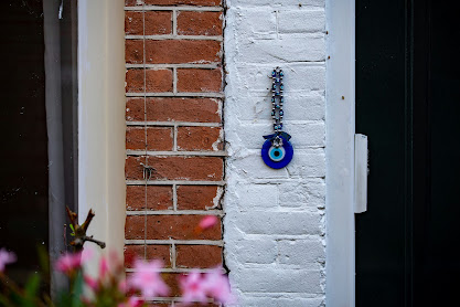 An evil eye amulet hangs beside a doorway