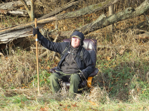 hiker in an office chair by the road