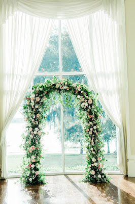 ceremony arch with greenery and flowers