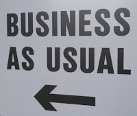 Business as usual sign with arrow pointing to the left