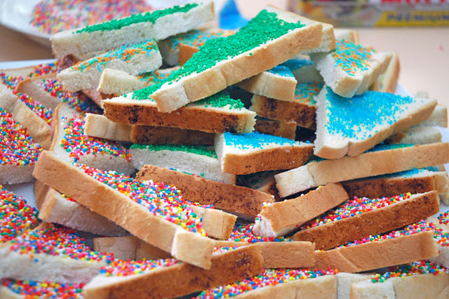 Fairy bread covered in rainbow colored sprinkles