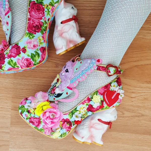 close up of shoes with butterfly cat detail and kitty shaped heel