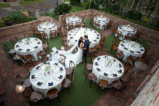 bride and groom standing between tables at casa feliz