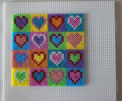 Mini Hama bead hearts on pegboard