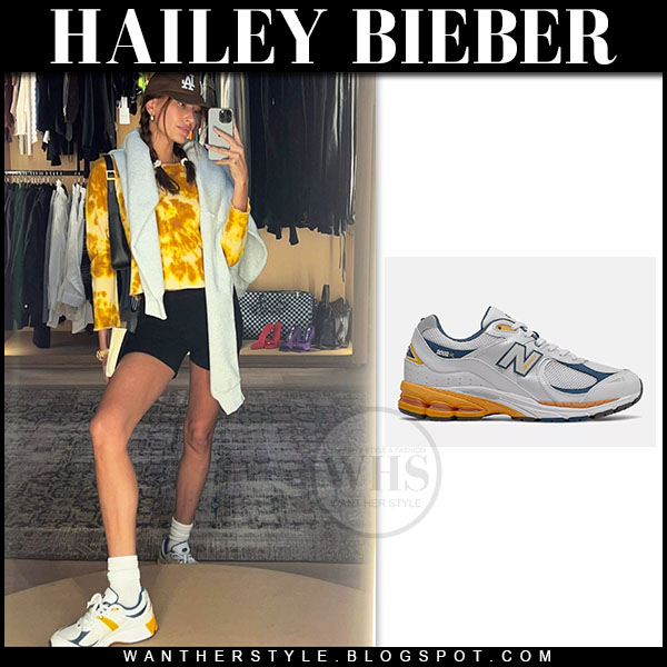 Hailey Bieber in yellow tie dye sweatshirt and New Balance sneakers on Marc...