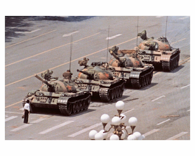 color photograph of A lone man stops a column of tanks near Tiananmen Square, 1989 Beijing, China. (Jeff Widener/AP)