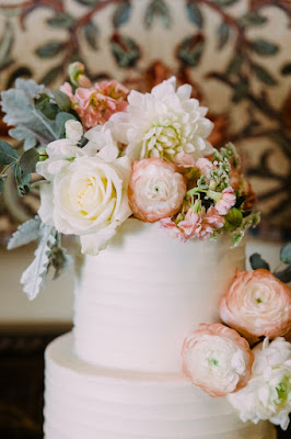 white and pink flowers on cake