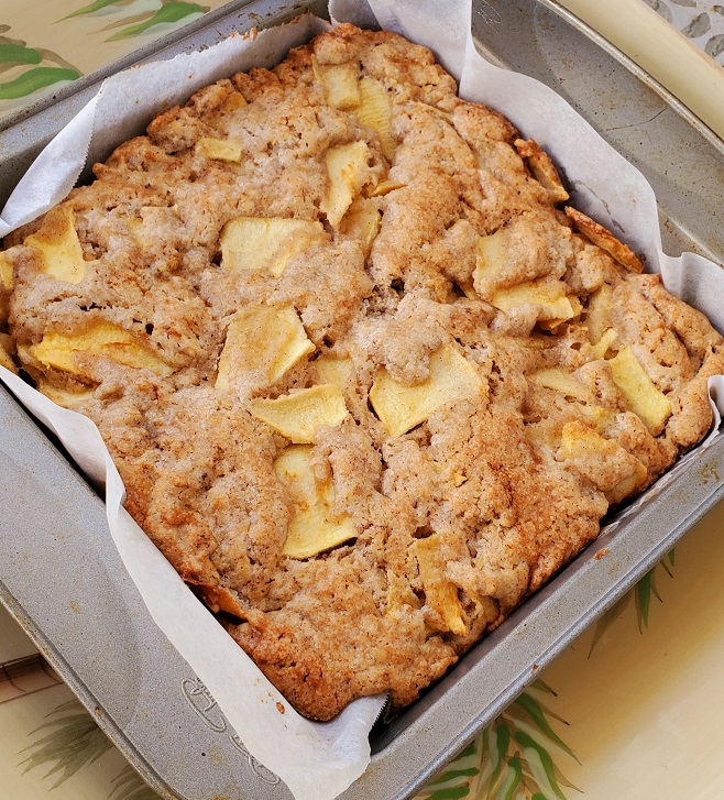 baked apple cake cooling in a square pan