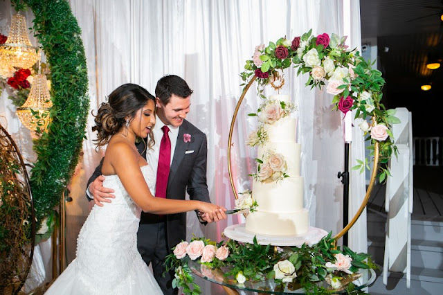 bride and groom cutting white 5 tier cake