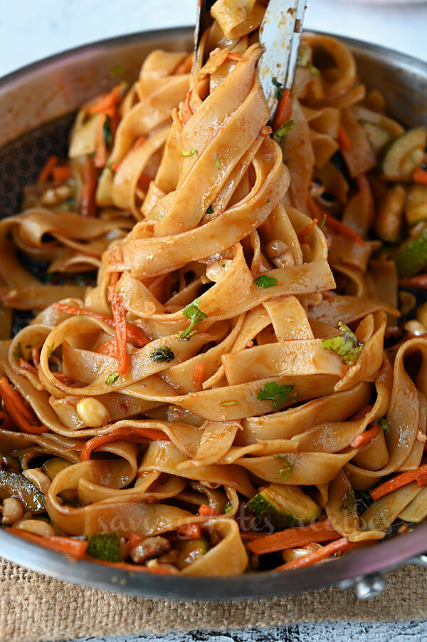 one pot spicy thai noodles with spicy sauce, noodles,peanuts,zuchini, carrots