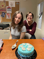 Two women (Cheyenne and Karin) with a blue cake