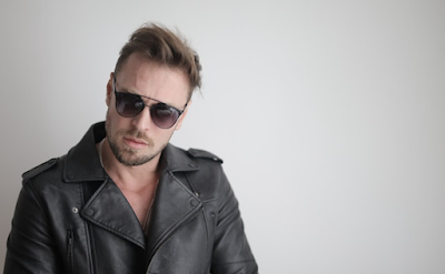 A Man Wearing Black Leather Jacket and Sunglass
