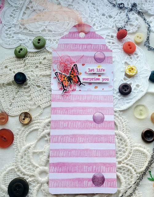 Pink and white decorated mail tag.