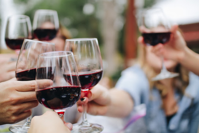 people clinking wine glasses:Photo by Kelsey Knight on Unsplash