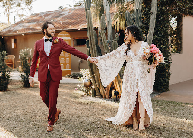 bride and groom holding hands