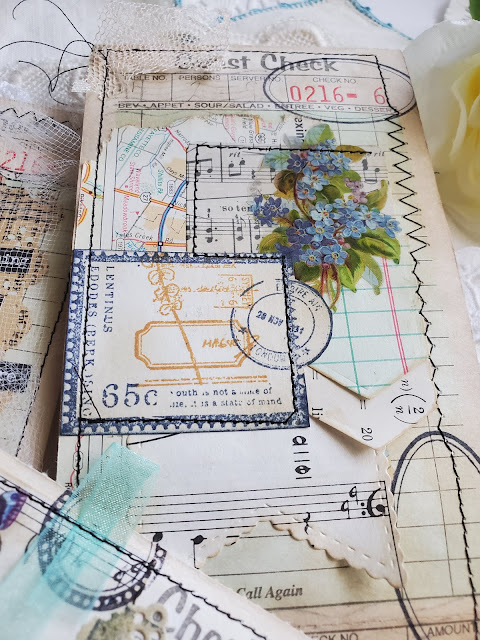 Guest check with music paper and rubber stamps collaged to it.