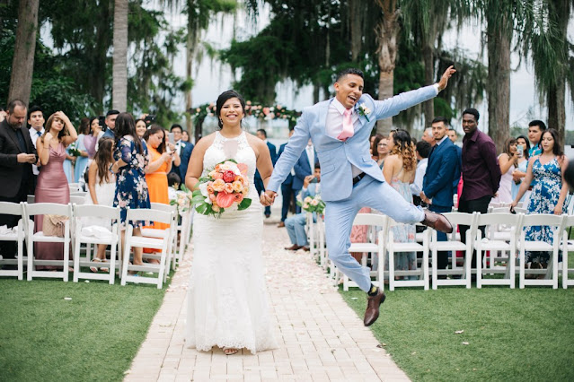 groom jumping for joy after wedding