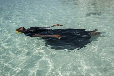 color photograph of young woman learning to float, in the Indian Ocean, off Nungwi, Zanzibar,  November 2016