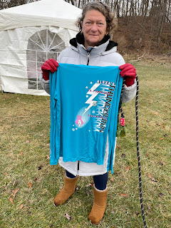 My mom holding up the race long-sleeved shirt.