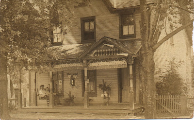 House with couple and young girl in a porch swing