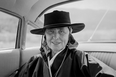 portrait of Georgis O'Keeffe in wide brim hat seated in backseat of car in New Mexcico, 1960