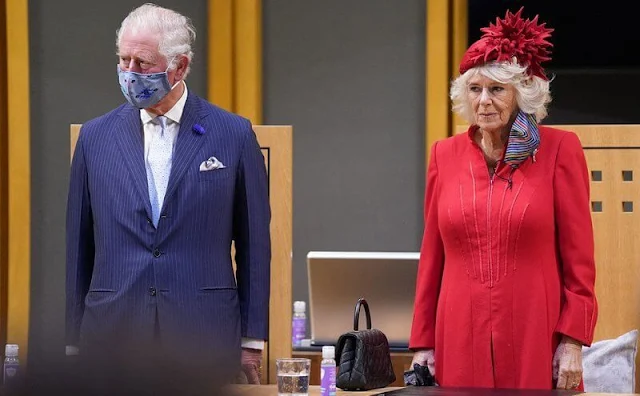 Queen Elizabeth wore a Stewart Parvin outfit. Rachel Trevor-Morgan hat. Welsh Daffodil brooch. Fiona Clare coat