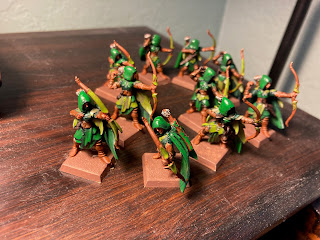 10 hooded elves with bows, painted in two shades of green.