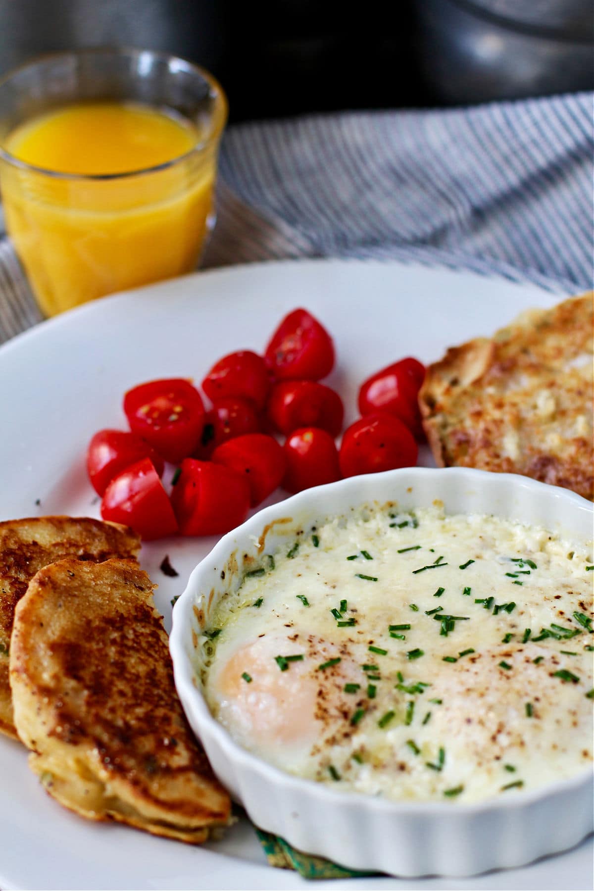 Baked eggs plated with tomatoes.