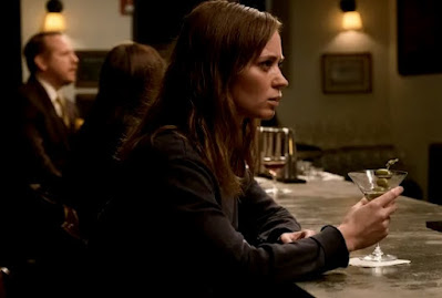 Emily Blunt looking harsh and drinking at the bar in a still from Girl on the Train