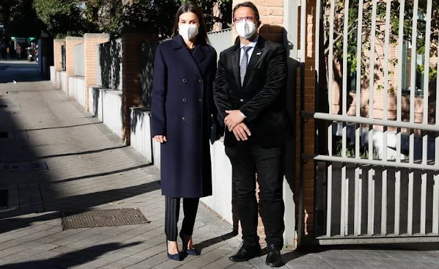 Queen Letizia wore kocani striped blazer and trousers suit from Hugo Boss, and navy wool coat from Hugo Boss