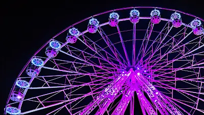 Ferris wheel With Purple Lights At Night Wallpaper