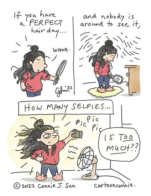 3-panel comic of a girl at home alone, having a perfect hair day. She looks into a handheld mirror, then down dejectedly. In the last frame, a fan is creating a wind effect, as she takes glamour shots on her phone in bunny slippers, with the best hair of her life. Caption reads: "If you have a perfect hair day and nobody is around to see it, how many selfies...is too much??" Original webcomic strip by Connie Sun, cartoonconnie
