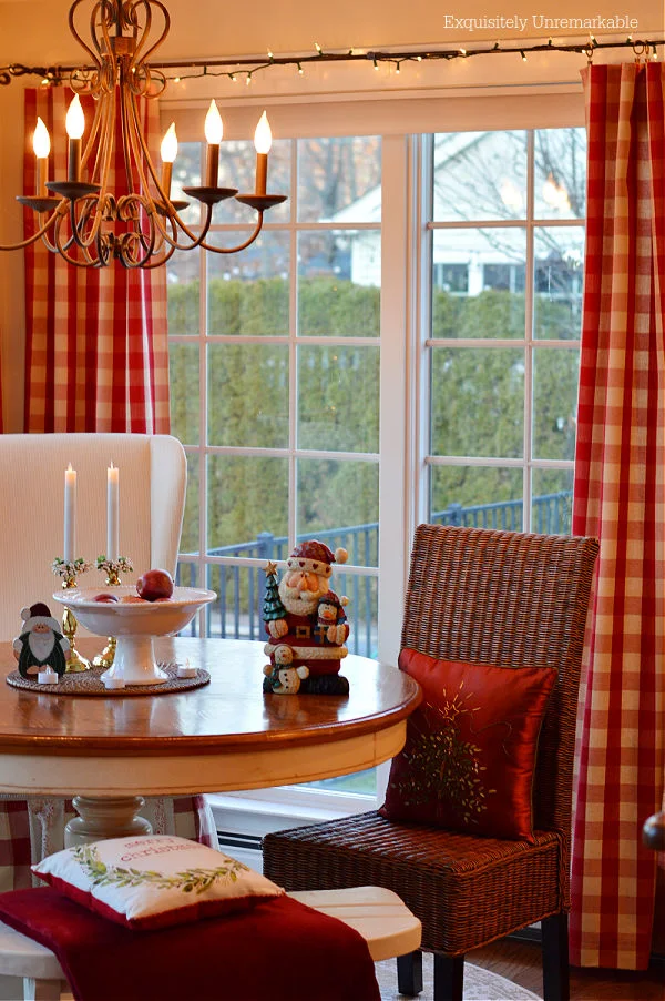 Christmas In The Kitchen with red curtains and pillows in round table nook