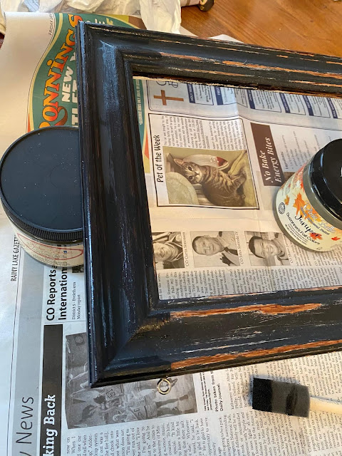 Photo of a frame being painted black.