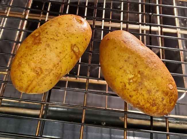 scrubbed baked potatoes ready for oven