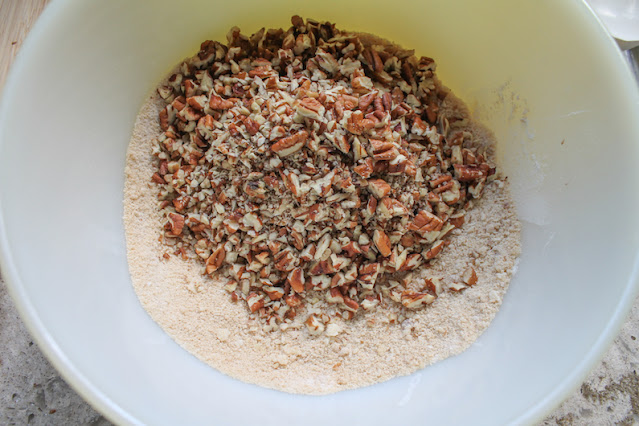 Adding the chopped pecans to the flour/sugar mixture