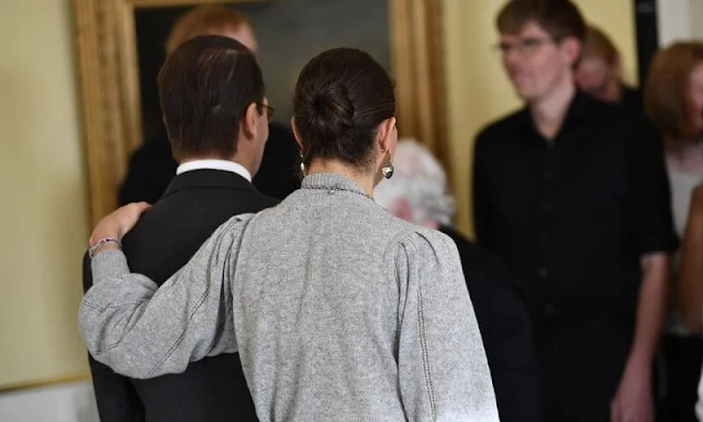 Crown Princess Victoria wore a grey cashmere knit jumper by H&M rhinestone detail necklace. H&M trousers and cape