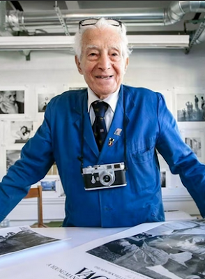 photograph of Tony Vaccaro with camera around his nexk