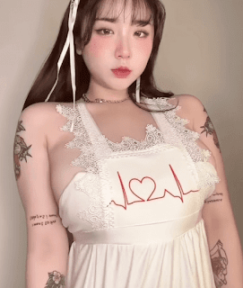 Fantrie model(BJ) ECHI is wearing a white apron and revealing tattoos on her arms.