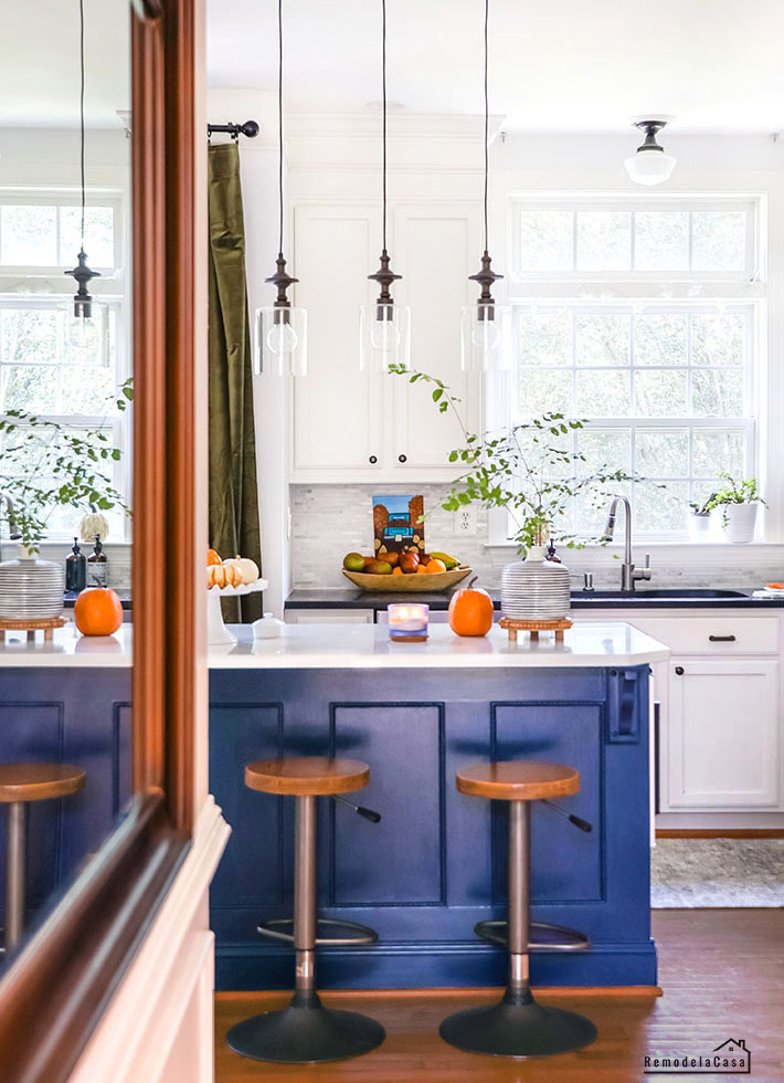 white kitchen with navy blue island