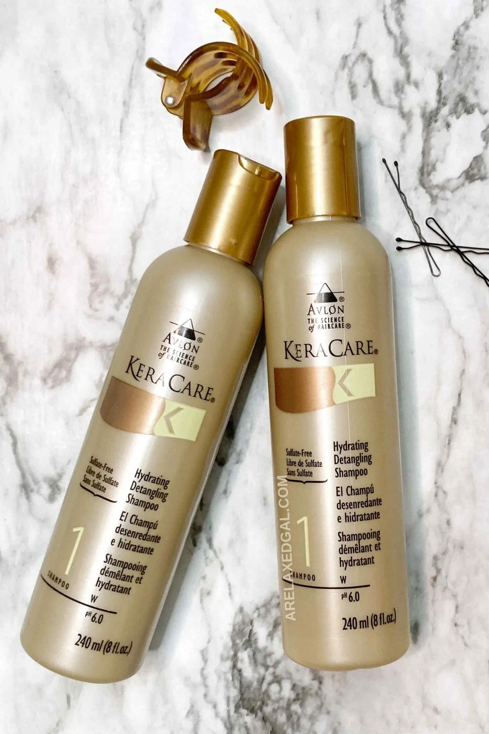 Two Keracare Hydrating Detangling shampoo bottles on a marble background.