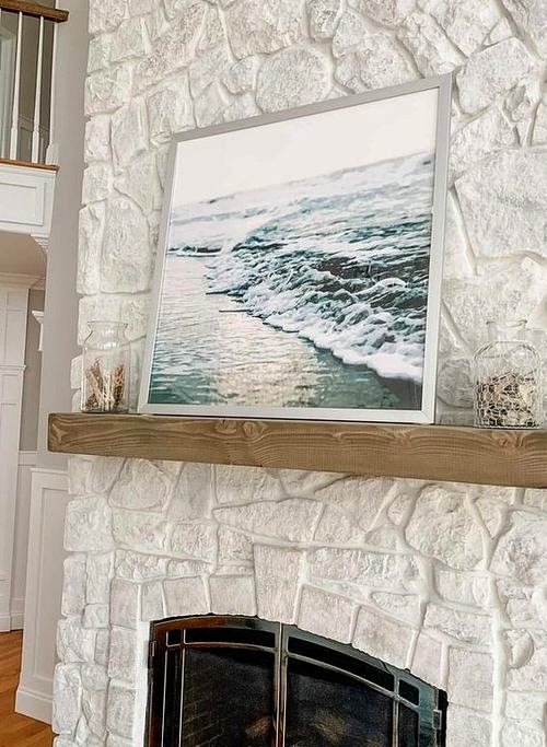 Framed Ocean Photo above Fireplace Decor Idea